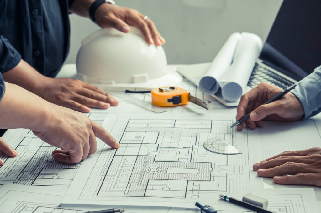 Team of architects and engineer working on construction plans